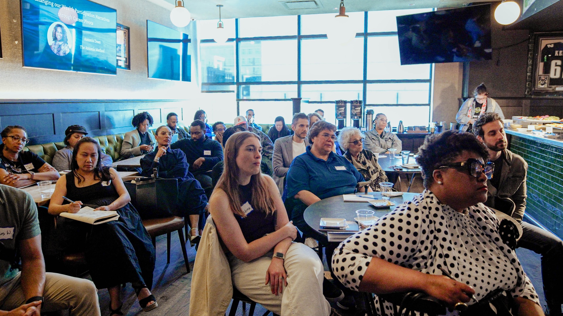 Participants in attentive conversation at a Re:Wealth gathering